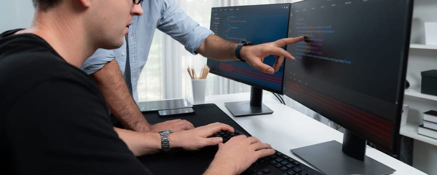 IT developers focusing on software development information on two screens with coding program on panorama view in application and website. Technical engineer coder on safety program concept. Sellable.