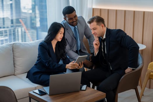 Group of skilled multiethnic businesspeople looking at data analysis by using tablet. Group of smart manager sharing, brainstorming, discussing, thinking about marketing strategy, idea. Ornamented