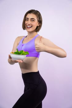 Full body length gaiety shot athletic and sporty young woman with healthy vegan food in standing posture on isolated background. Healthy active and body care by vegetarian lifestyle.