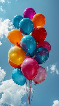 Vibrant balloons against a backdrop of a clear blue sky, symbolizing celebration and joy.