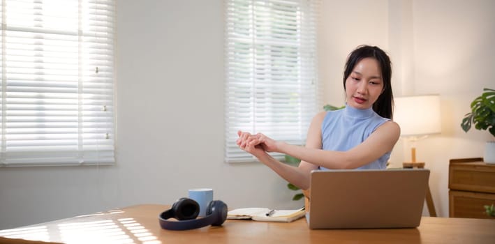 Asian college student sit at home studying online using a video calling program on their laptop..