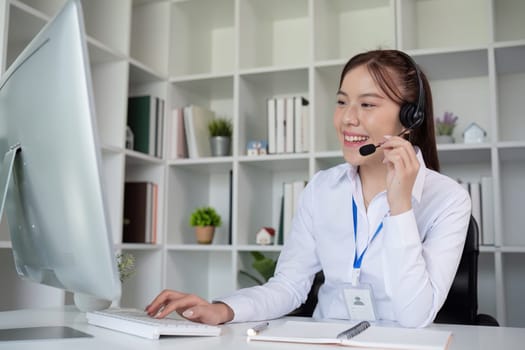 Call center agents wear headphones to talk to customers. Provide consultation via online channels on laptops.