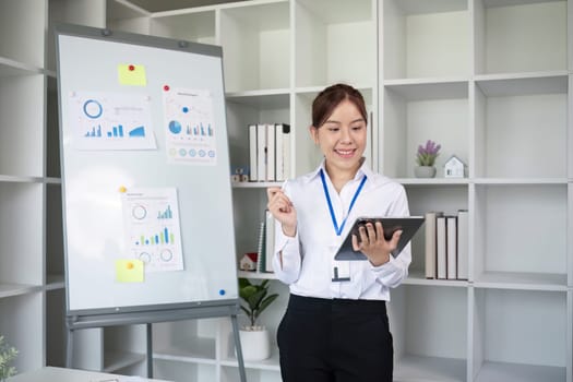 Businesswoman with presentation board at a meeting about work plans Finance and business results graphs.