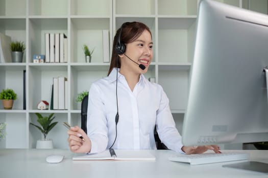 Call center agents wear headphones to talk to customers. Provide consultation via online channels on laptops.