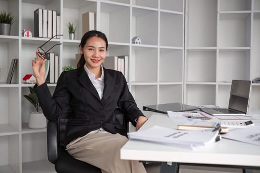 Portrait of a beautiful businesswoman on her desk in the office.