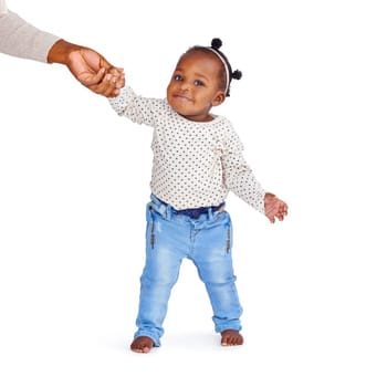 Baby, parent and help walking in studio for fashion, jeans or clothing or development. Girl, isolated on backdrop or standing support with person for trend, holding hands or smile or kid in Brazil.