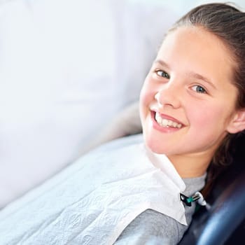 Portrait, girl and dentist chair for mouth exam, hygiene or wellness in consultation room. Face, teeth whitening or happy kid consulting orthodontist for treatment or tooth growth and development.