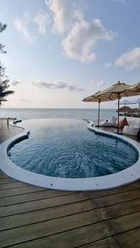 Bangsaray Pattaya Thailand 28 February 2024, A stunning, large swimming pool blends seamlessly with a wooden deck under the open sky.