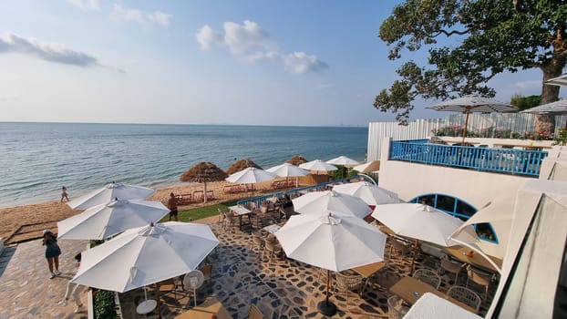 Bangsaray Pattaya Thailand 28 February 2024, A group of colorful umbrellas stand tall on a sandy beach, casting shade and adding a burst of color to the peaceful scene.