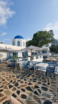 Bangsaray Pattaya Thailand 28 February 2024, A peaceful patio area with tables and chairs set against a serene blue dome in the background.