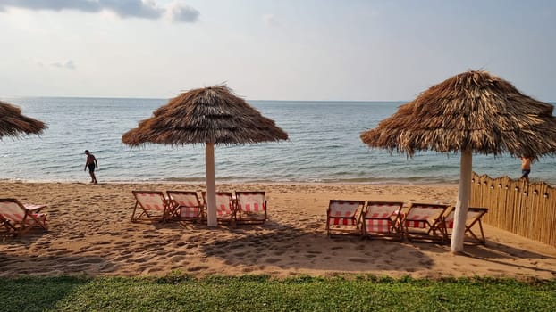 Bangsaray Pattaya Thailand 28 February 2024, Chairs and umbrellas adorn a tranquil beach near the ocean, inviting relaxation and enjoyment of the scenic coastal views.