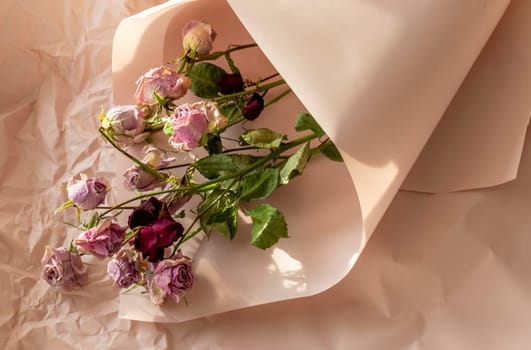 Concept shot of the background theme, wrapping paper, dried roses other flowers and other arrangements.