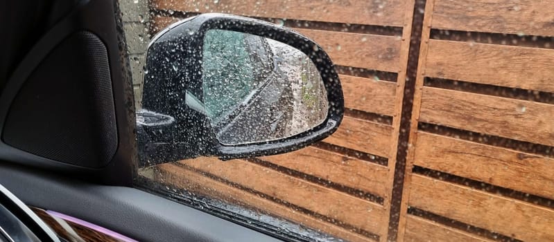 Concept shot of the car window covered by rain drops