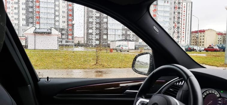 Concept shot of the car window covered by rain drops