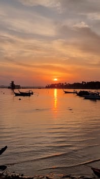 A mesmerizing view of a group of boats gracefully floating on the shimmering water, creating a picture-perfect scene of tranquility and adventure. Koh Mook Thailand