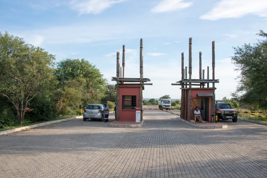 cars and people wating to enter the kruger national park in south africa for safari ,entrance kruger national park orphan gate
