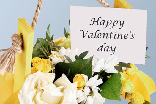 Happy Valentine's day text on paper in a basket with flowers.The concept of gifts and celebrations
