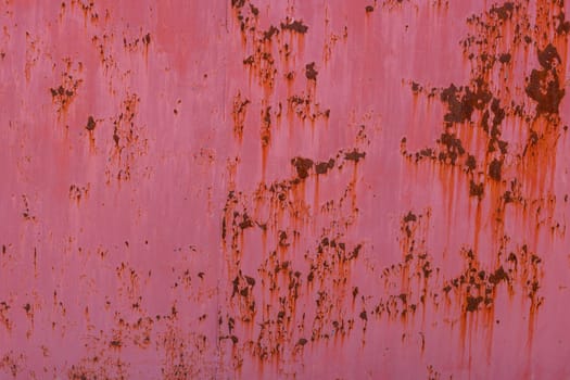 rusty red sun-bleached paint paint on flat sheet metal surface full-frame background and texture.