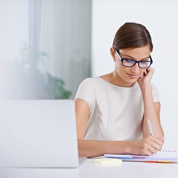 Businesswoman, laptop and writing notes for planning, inspiration and schedule agenda in office. Female person, administration and online calendar for tasks, receptionist and journal for information.