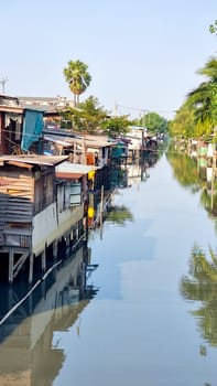 Bangkok Thailand 13 January 2024, , Serene body of water featuring charming houses floating on its surface, creating a picturesque scene of unique living arrangements.