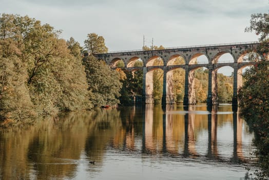 Railway Bridge with river in Bietigheim-Bissingen, Germany. Autumn. Railway viaduct over the Enz River, built in 1853 by Karl von Etzel on a sunny summer day. Bietigheim-Bissingen, Germany. Old viaduct in Bietigheim reflected in the river. Baden-Wurttemberg, Germany. Train passing a train bridge on a cloudy day in Germany