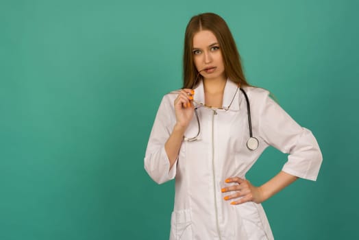 Beautiful smiling sexy nurse or femele doctor standing isjlated on background .