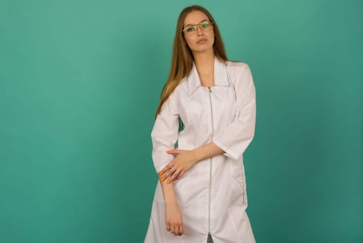 Beautiful smiling sexy nurse or femele doctor standing isjlated on background .