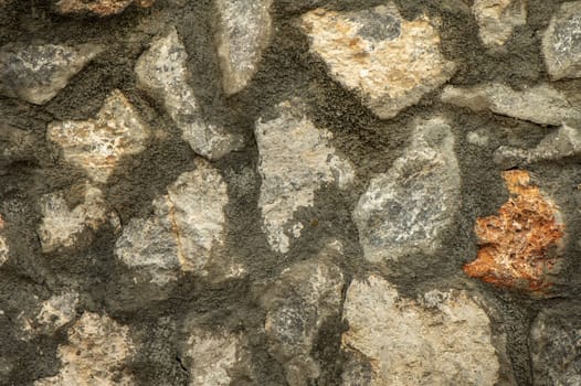 House wall made of natural stones and shell rock as background