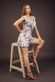 Young attractive woman posing in the studio. A full-lipped girl has problems with skin on her face and body, disease of psoriasis. She does not lose heart and lives a full life wants to become a model