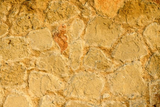 A solid beige colored stone wall suitable for the background.