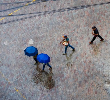 Areal concept shot of the people walking under the rain