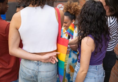 Group of young LGBTQ people preparing for gay pride parade outdoors.