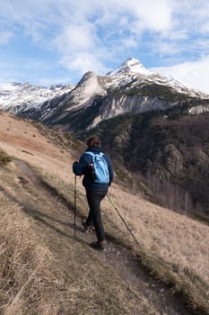 Hiker walking on the path in Pyrenees mountains near Gavarnie, High quality photo