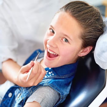Girl, child and portrait at dentist for mouth with healthcare tool, consultation or dental inspection for oral health. Professional, kid patient or hand for teeth cleaning, gingivitis or medical care.