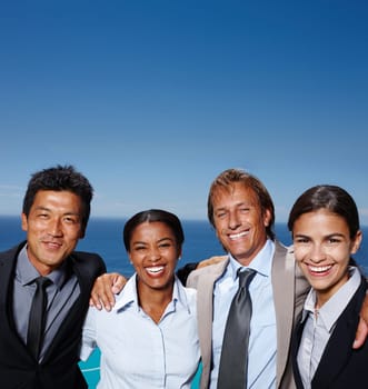 Corporate, portrait and business people with smile by ocean for team building, collaboration and support. Diversity, employees and happy by sea in nature for company cruise, travel and partnership.