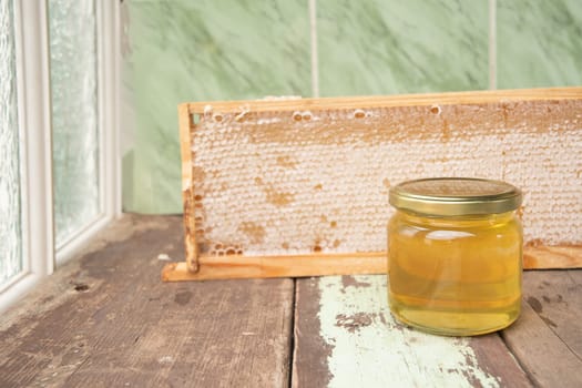 full honeycomb and jar of honey, organic fortified beekeeping product for healthy eating, alternative medicine, high quality photo