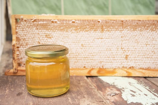 full honeycomb and jar of honey, organic fortified beekeeping product for healthy eating, alternative medicine, high quality photo