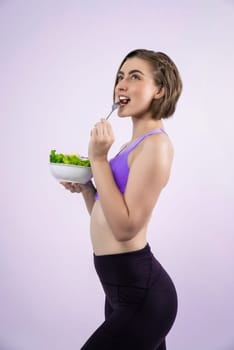 Full body length gaiety shot athletic and sporty young woman with healthy vegan food in standing posture on isolated background. Healthy active and body care by vegetarian lifestyle.