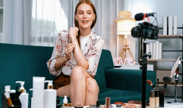 Woman influencer shoot live streaming vlog video review makeup utmost social media or blog. Happy young girl with cosmetics studio lighting for marketing recording session broadcasting online.