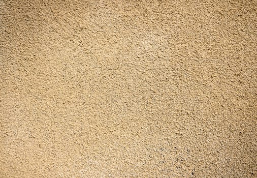 A sand beige colour stock photo of a newly plastered wall