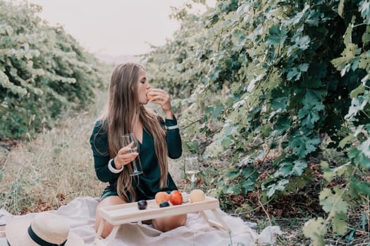 Picnic and wine tasting at sunset in the hills of Italy, Tuscany. Vineyards and open nature in the summer. Romantic dinner, fruit and wine.