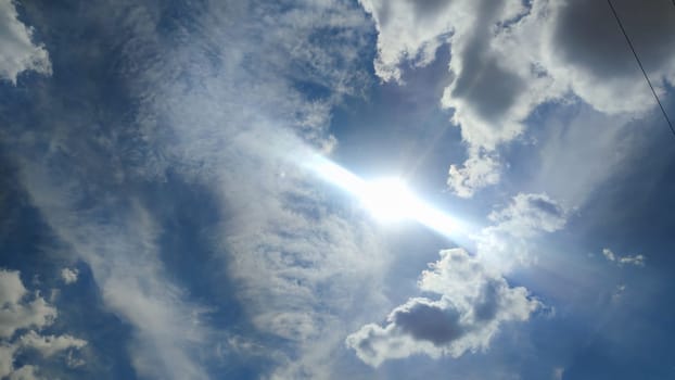 Blue gray light sky nature white clouds whether background, sun face . High quality photo