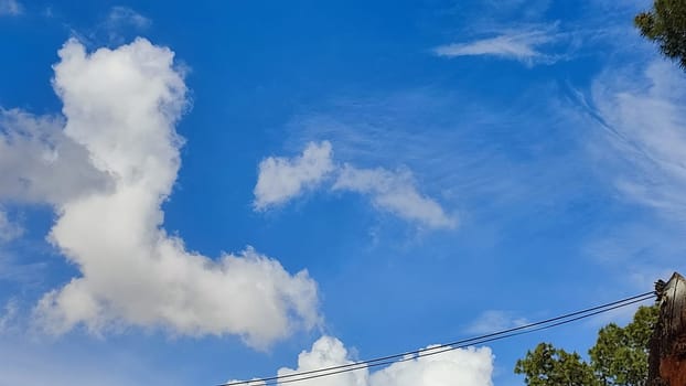 Blue gray light sky nature white clouds whether background, sun face . High quality photo