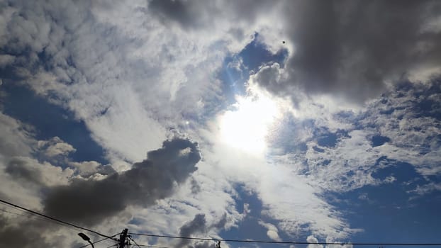 Blue gray light sky nature white clouds whether background, sun face . High quality photo