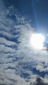 Blue gray light sky nature white clouds whether background, sun face . High quality photo