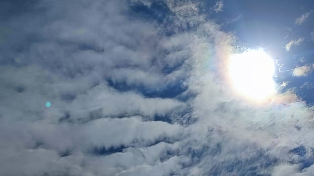 Blue gray light sky nature white clouds whether background, sun face . High quality photo