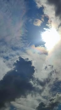 Blue gray light sky nature white clouds whether background, sun face . High quality photo