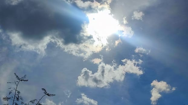 Blue gray light sky nature white clouds whether background, sun face . High quality photo