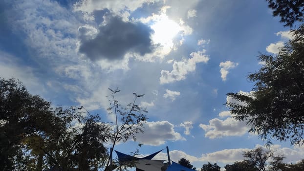 Blue gray light sky nature white clouds whether background, sun face . High quality photo