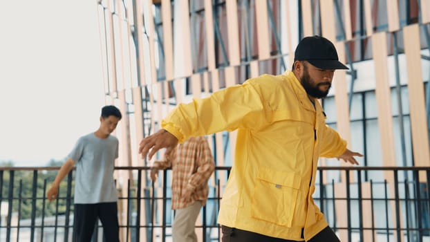 Hip hop team dance break dance while multicultural friend surrounded and clapping hands to cheer or encourage his friend to dance. Active and energetic street dance. Outdoor sport 2024. Endeavor.